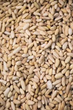 Thousands of unshelled pine kernels closeup in display Foto stock