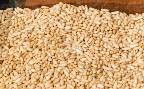 Thousands of unshelled pine kernels closeup in display Foto stock