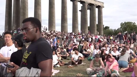 Thousands watch the solar eclipse in Edinburgh Stock Footage 342067910