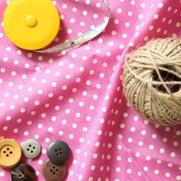 Thread and buttons and tape measure on fabric Background 写真素材