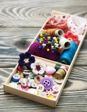 Thread and material for handicrafts in box on a wooden background Stock Photos