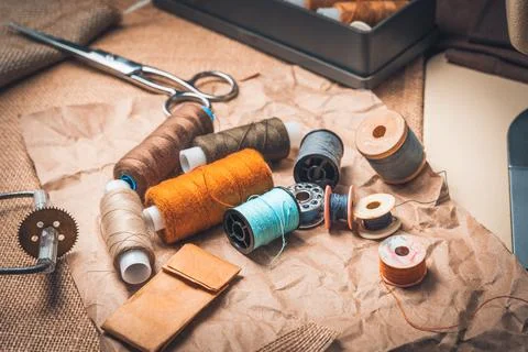 Thread and scissors on kraft paper. Side view Stock Photos