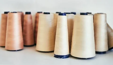 The thread that binds everything together. spools of thread in a workshop. Stock Photos