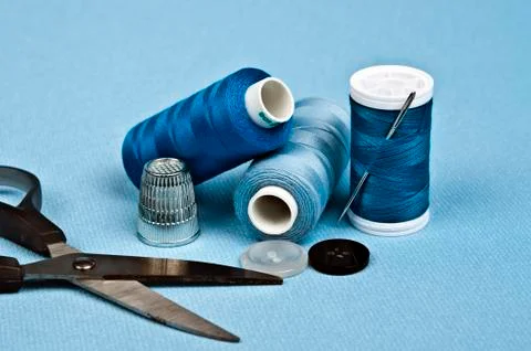 Thread on blue material background Stock-Fotos