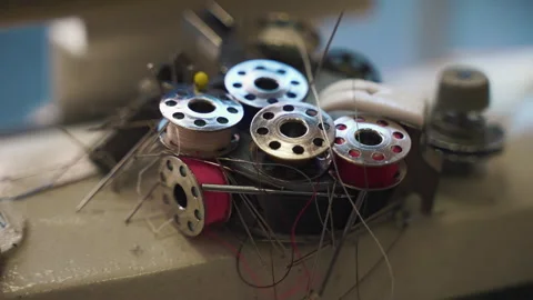 Thread bobbins, needles and fabric straight pins on magnet in tailor's atelier Stock Footage 250018893