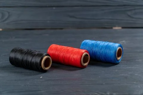 Thread coils black red and blue Stock Photos