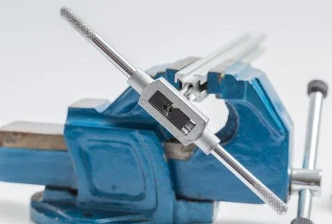 Thread cutting with a vise and taps Stock Photos