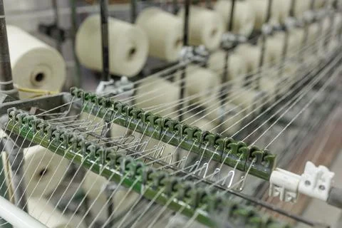 Thread guides on industrial weaving machine in textile production Stock Photos
