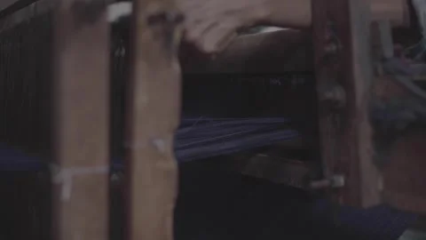 The thread of the loom is being repaired by the weaver Stock Footage 248799231