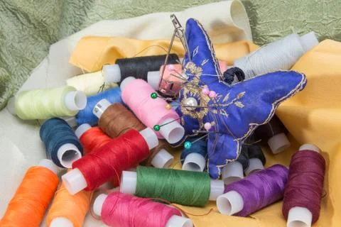 Thread, needles and fabrics for sewing Stock Photos