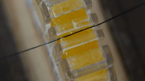 Thread to passing through Bees wax block. Waxed thread will catch, tear and knot Stock Footage 128136986