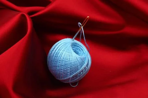 Thread on red silk Stock Photos