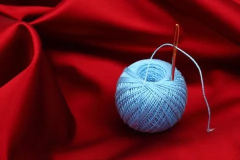 Thread on red silk Stock Photos