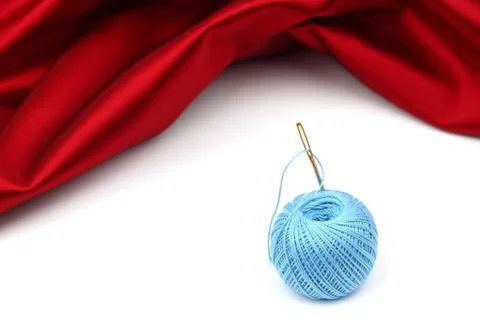 Thread on red silk Stock Photos