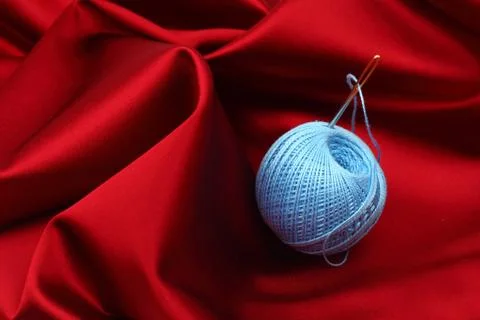 Thread on red silk Stock Photos