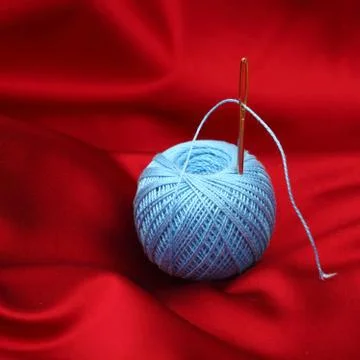 Thread on red silk Stock Photos