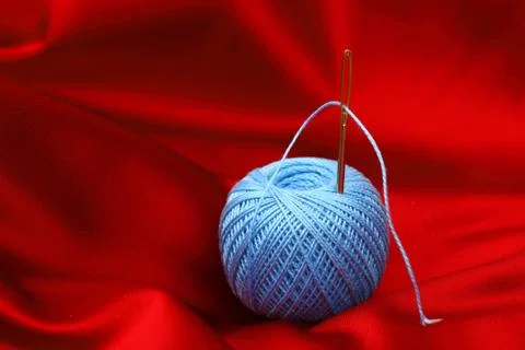 Thread on red silk Stock Photos