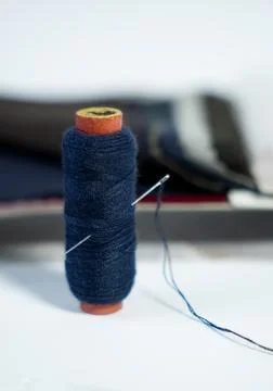 Thread Reel With Needle in it Over White. Foto stock