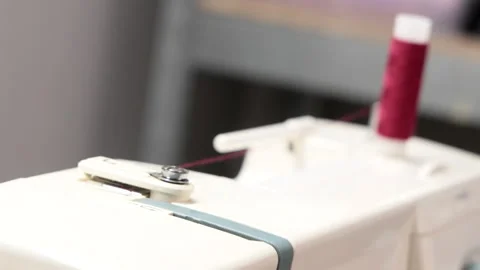 Thread Spool Rotating on Sewing Machine Stock Footage 306741700
