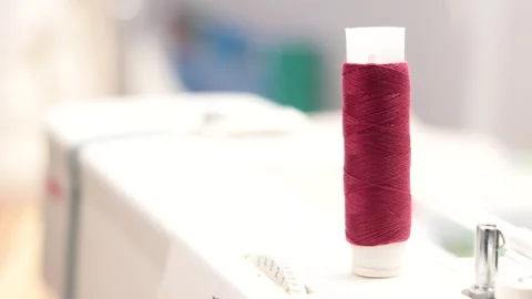 Thread Spool Spinning on a Sewing Machine Stock Footage 306741429