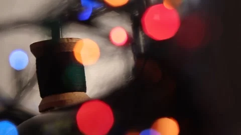 Thread on a spool under colored lights 2 Stock Footage 318314149