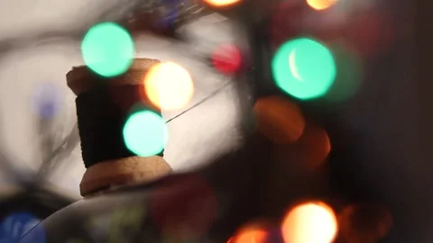 Thread on a spool under colored lights 4 Stock Footage 318314231