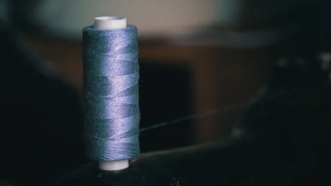 Thread From the Spool is Wound Onto a Bobbin for Sewing in a Sewing Machine Stock Footage 229537187
