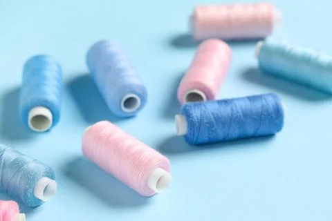 Thread spools on blue background 写真素材
