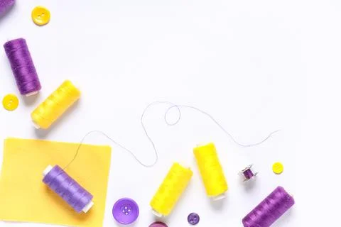 Thread spools with buttons and fabric on white background 写真素材