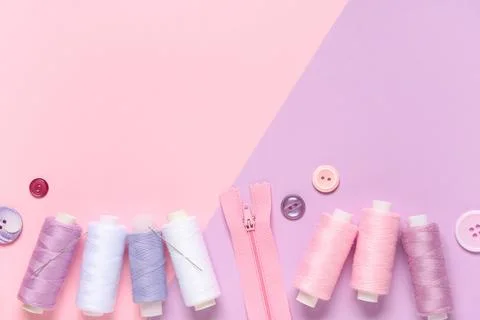 Thread spools with buttons and zipper on color background 写真素材