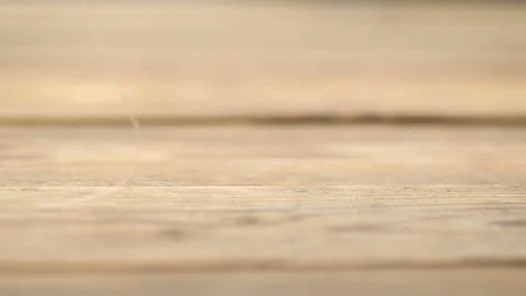Thread spools fall onto a rustic table. Video stock 127419005