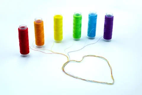 Thread spools with a heart shape. LGBT community rights support concept. Stock Photos