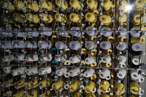 Thread spools of an industrial weaving loom for fabrication of f Stock Photos