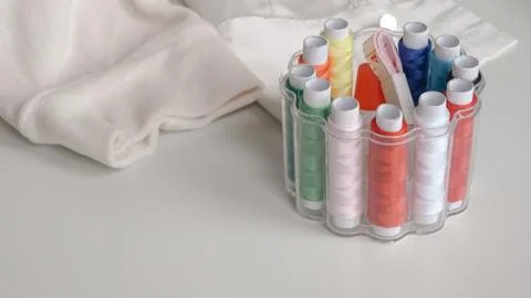 Thread spools in organizer with soft fabric on white background for sewing Stock Photos