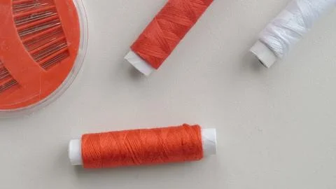 Thread spools in organizer with soft fabric on white background for sewing Stock Photos