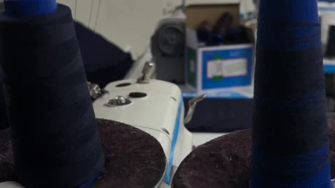 Thread spools rotating on sewing machine during operation, textile production Stock Footage 337120434