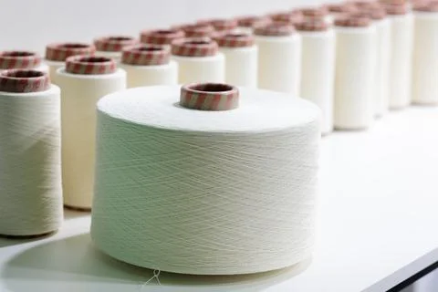 Thread spools used in fabric and textile industry Stock Photos