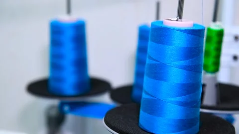 Thread spools for weaving in automatic sewing machines in tailor colorful i.. Stock Footage 321241801