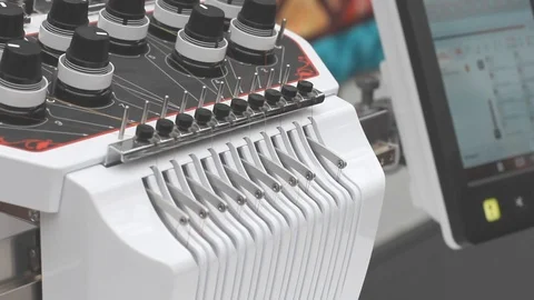 The thread tensioner works in a multi-color embroidery machine Stock Footage 125434064