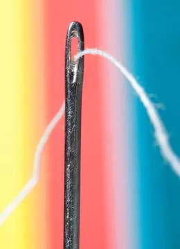 Thread through needle hole Stock Photos