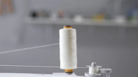 Thread is unwound from the reel during sewing, woolen thread and felt, clothing Stock Footage 78002744