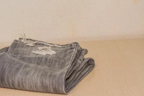 Threadbare black denim pants Stock Photos