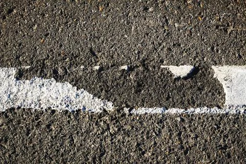 Threadbare white road line on the asphalt close-up Stock Photos