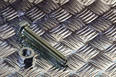 Threaded Hex Nut And Bolt On Tread Plate Stock Photos