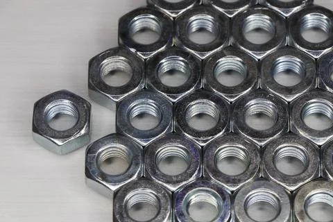 Threaded Metal Hex Nuts Sorted On White Surface Stock Photos