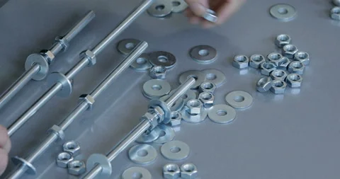 Threaded rod with washer and nut screwing, close up Stock Footage 145658541