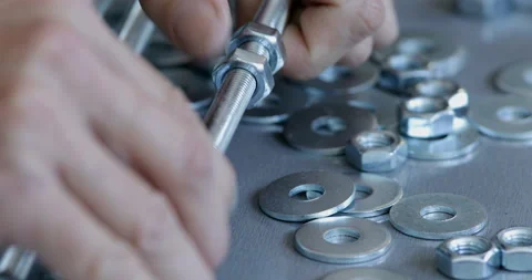 Threaded rod with washer and nut screwing, close up Stock Footage 145659031