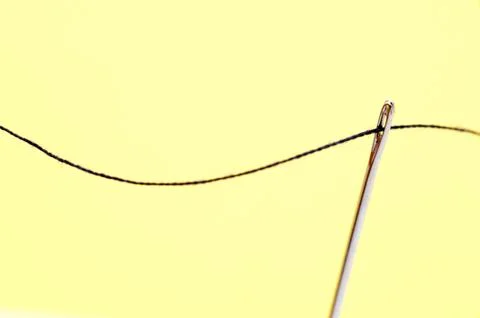 Threaded sewing needle Stock Photos