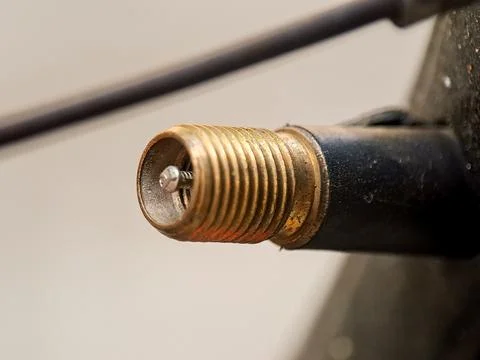 Threaded valve stem with a small screw is presented in a neutral and simple.. Stock Photos