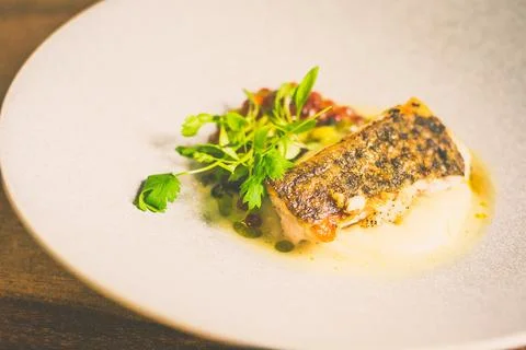 Threadfin with yucca mash, fermented tomato fish jus, laksa oil, pickled fa.. Foto stock